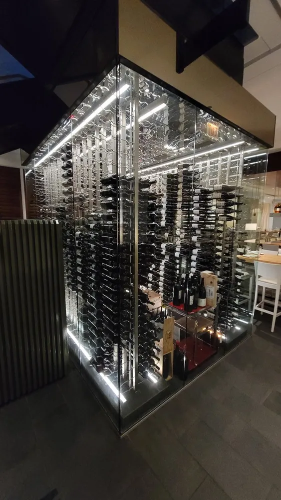 original glass wine bar illuminated by electrician using recessed lights